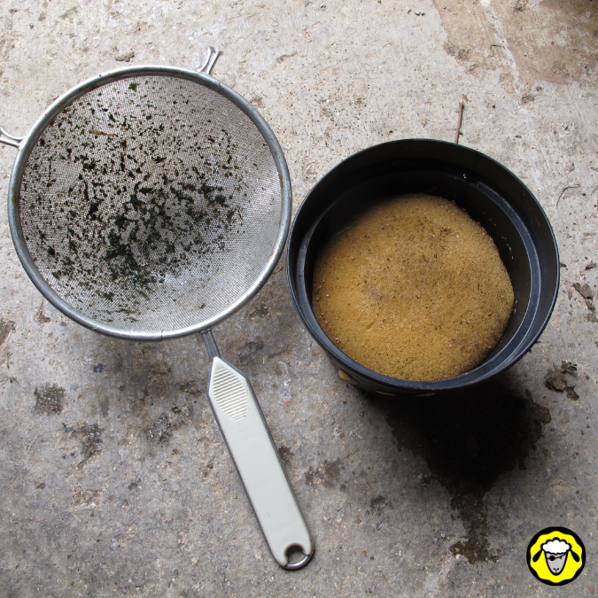 Filtre improvisé mais efficace pour éviter que trop de débris ne tombe dans une cuve d'eau pluie : passoire de cuisine, pot de fleur et éponge.