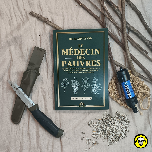 Livre "Le Médecin des Pauvres" accompagné d'un couteau, d'un filtre à eau, de graines de tournesol et de branches sur un tissu beige.