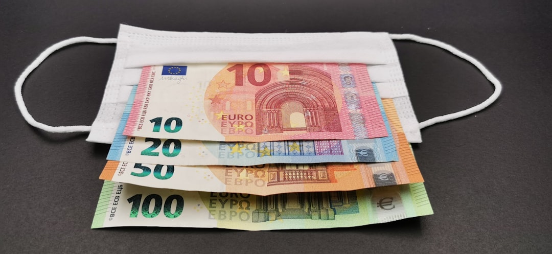 Photo by Nedret Binici a stack of money sitting on top of a table