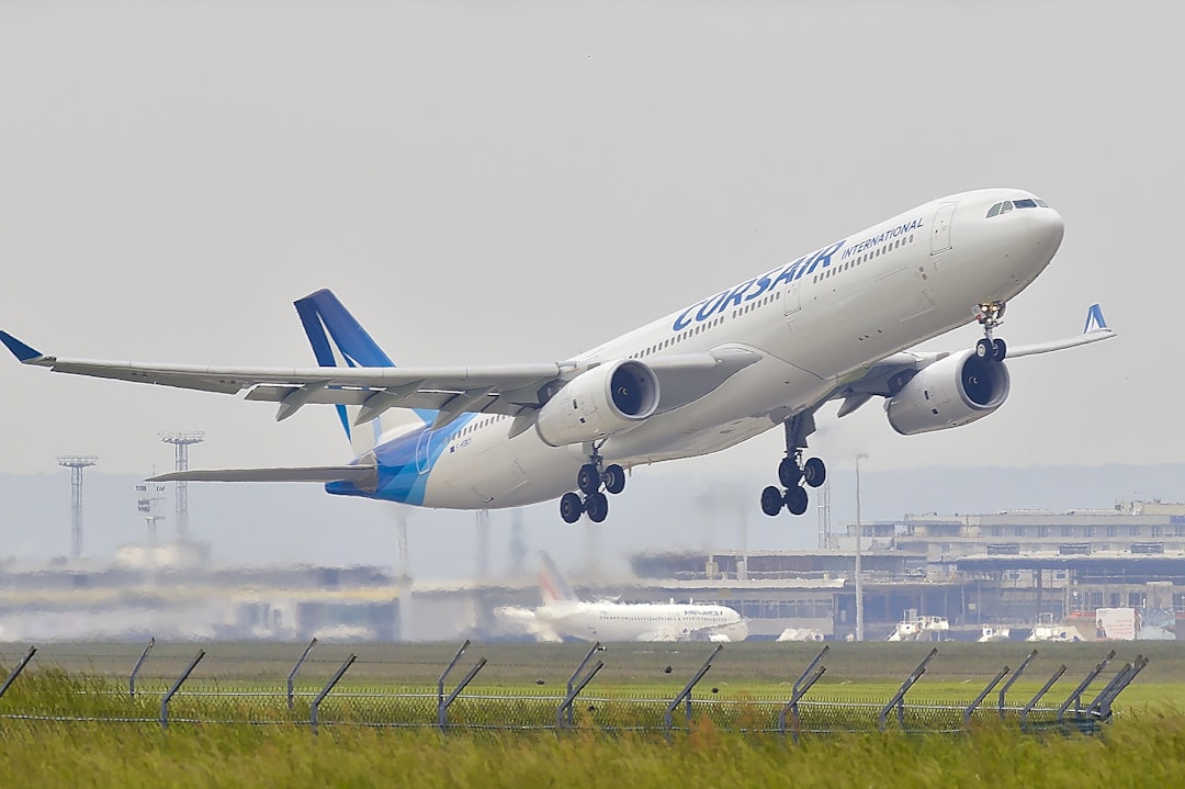 Photo by Daniel Eledut white and blue airplane about to fly at the airport