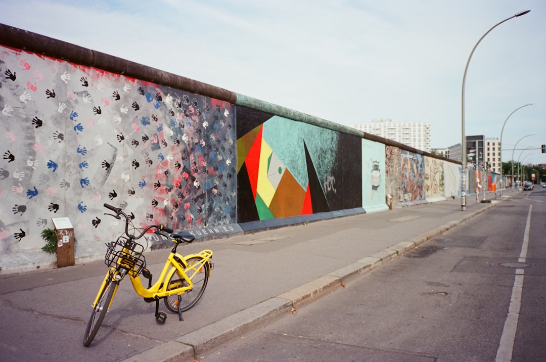 Photo by Yc Liao yellow bicycle near wall