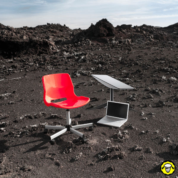 Setup minimaliste avec chaise, laptop et routeur satellite installé sur un terrain volcanique, montrant la possibilité de télétravailler en zone totalement isolée.