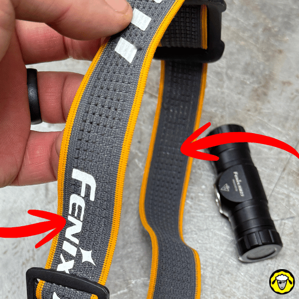 Bandeau Fenix gris et orange et lampe HM23 séparée, flèches rouges montrant la séparation et le sens.