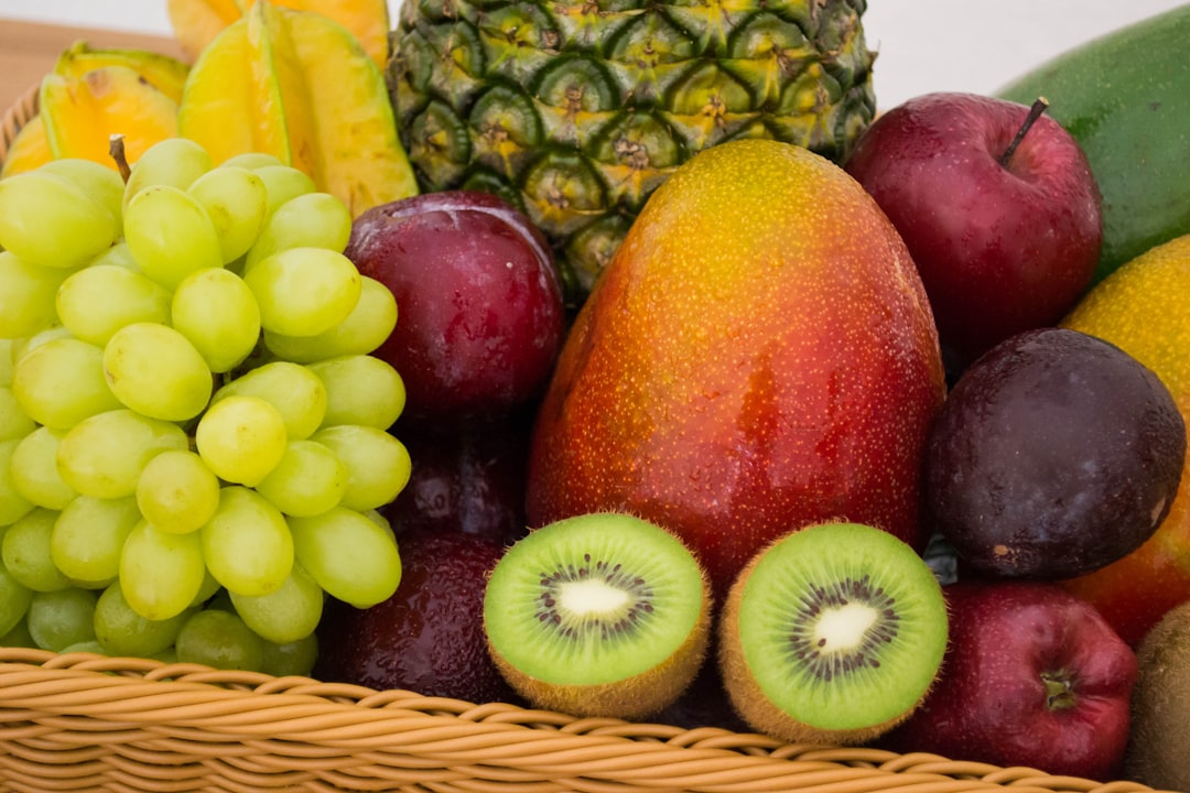 Photo by Jonas Kakaroto red apple fruit beside green apple and yellow fruit on brown woven basket