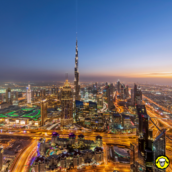 Vue aérienne de la skyline de Dubaï au crépuscule avec le Burj Khalifa et les autoroutes illuminées