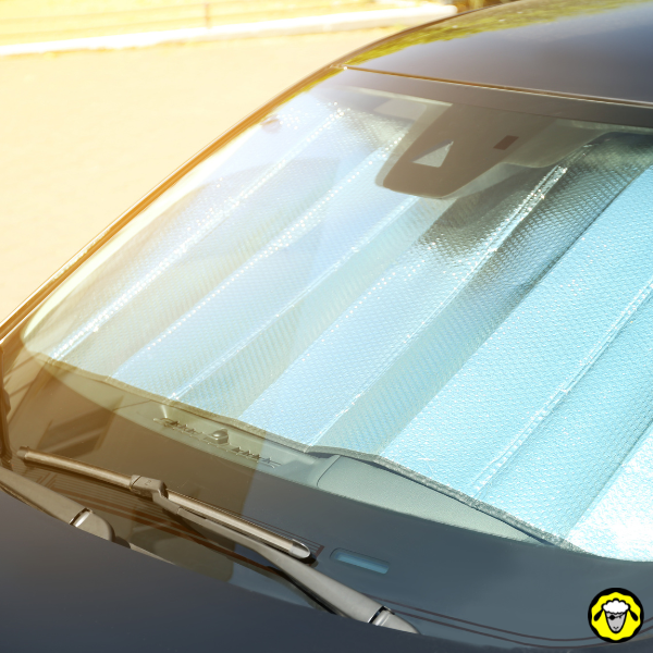 Pare-soleil réfléchissant derrière le pare-brise d une voiture Pare-brise de voiture avec pare-soleil réfléchissant bleu à l intérieur, en plein soleil
